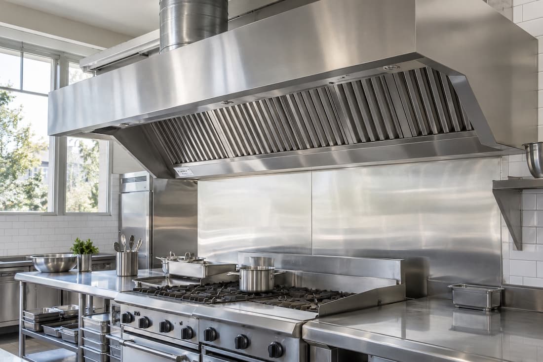 Close view of commercial canopy baffle filters, stainless hood and exhaust duct